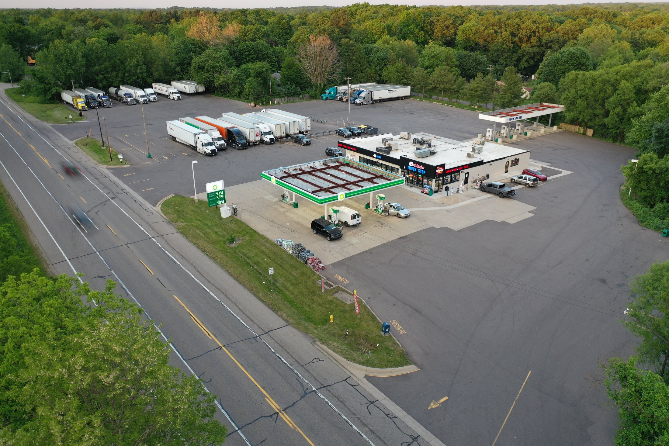 Aerial view of Arlene's Truck Stop, BP fuel canopy, truck parking, and diner on W Columbia Ave